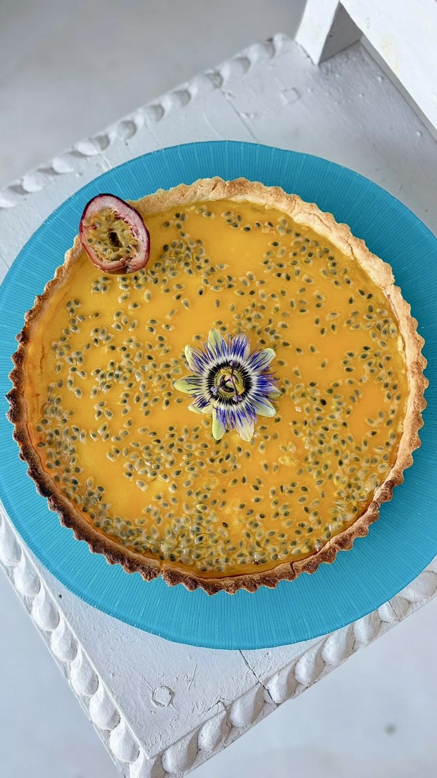 Passion fruit tart decorated with an edible flower