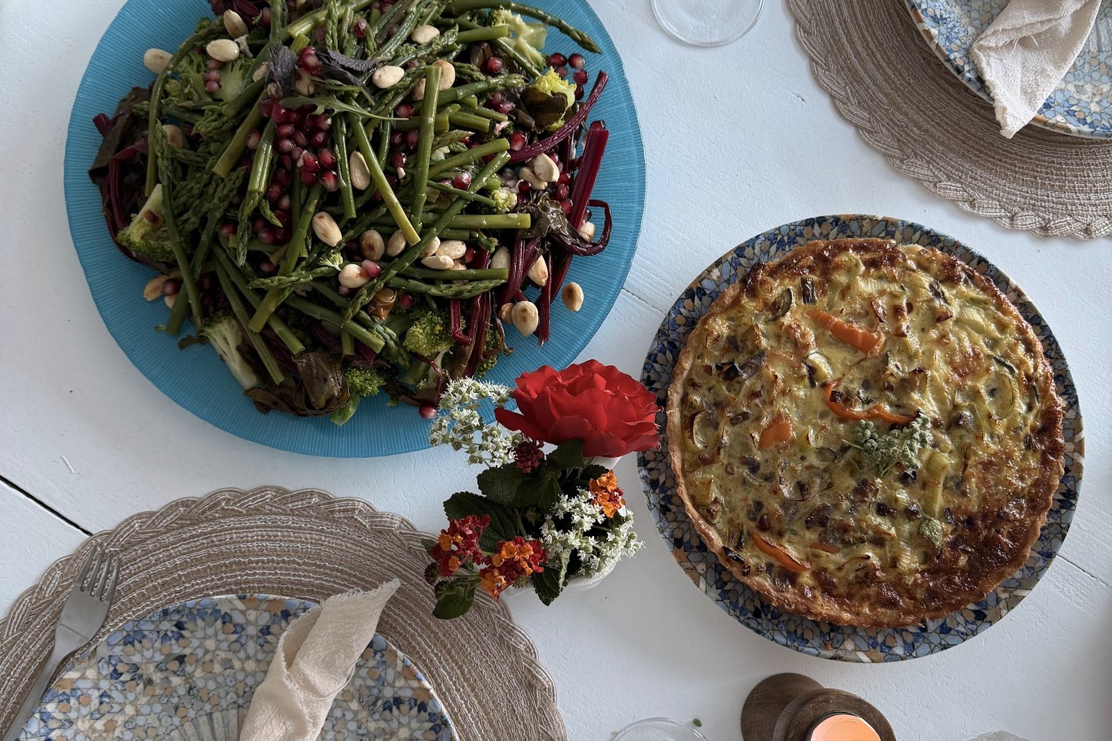 Candlelit table with salad and tart