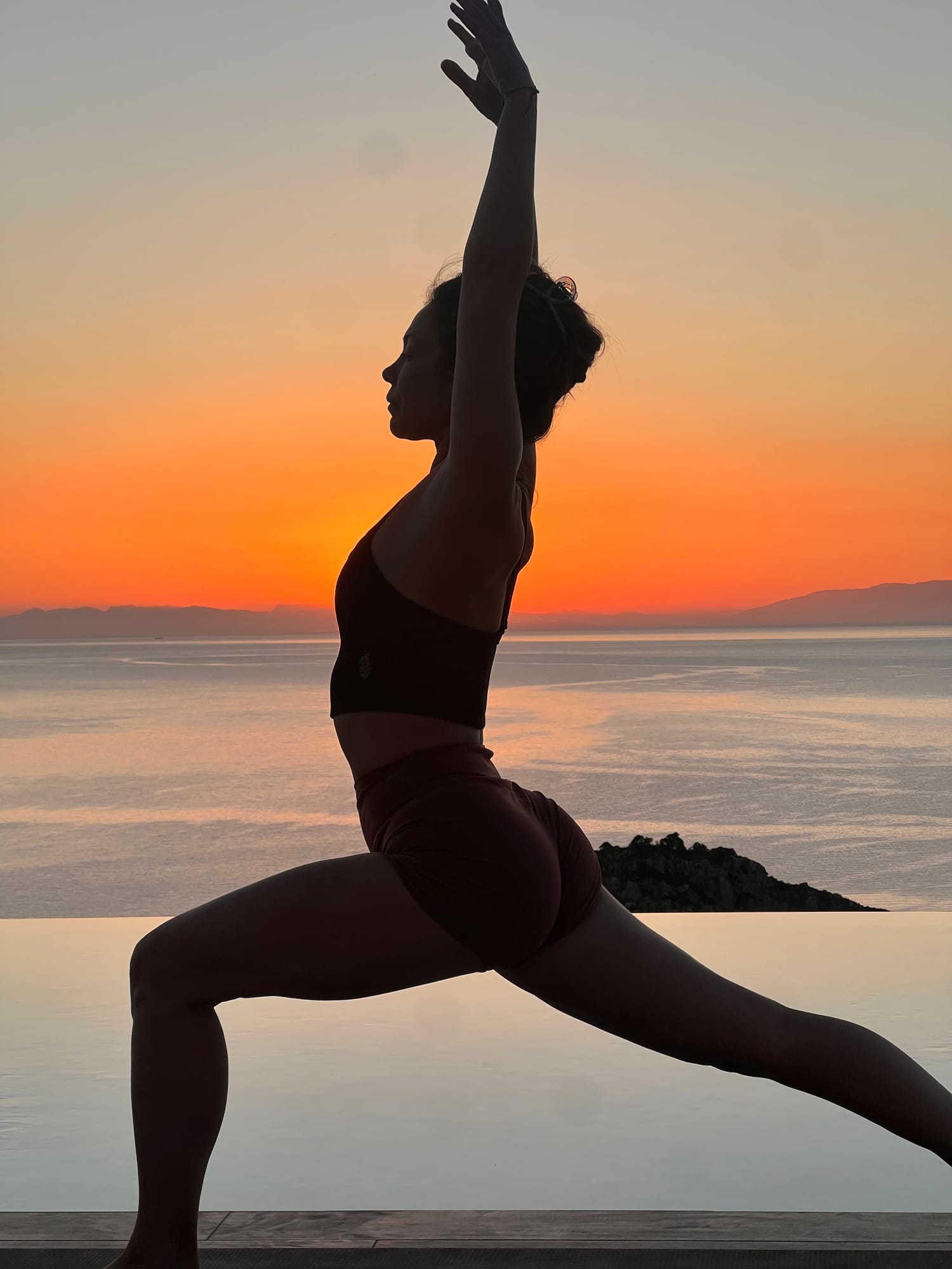 A woman watching the sunset over the sea in Zakynthos