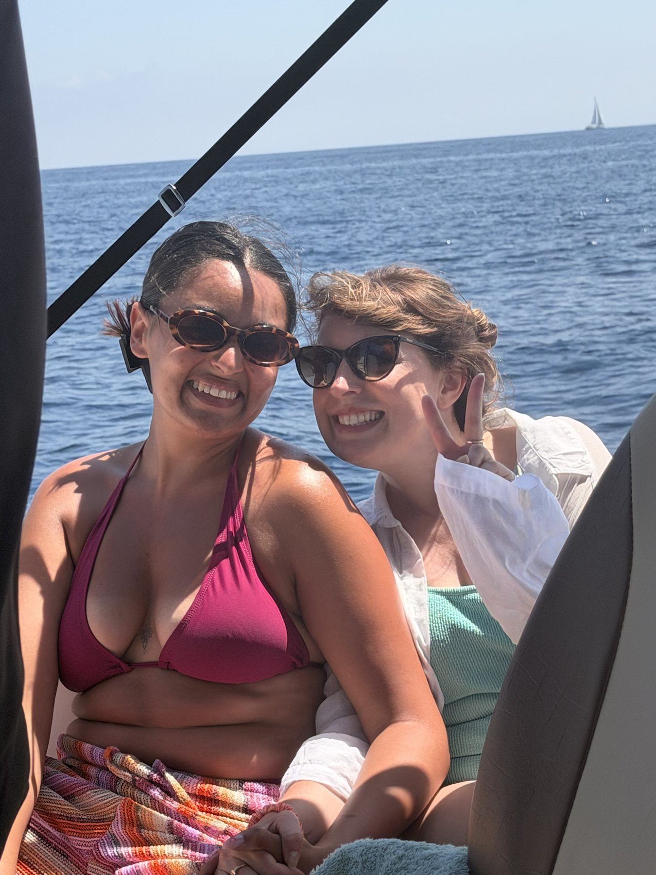 Two guests smiling on a boat day at sea