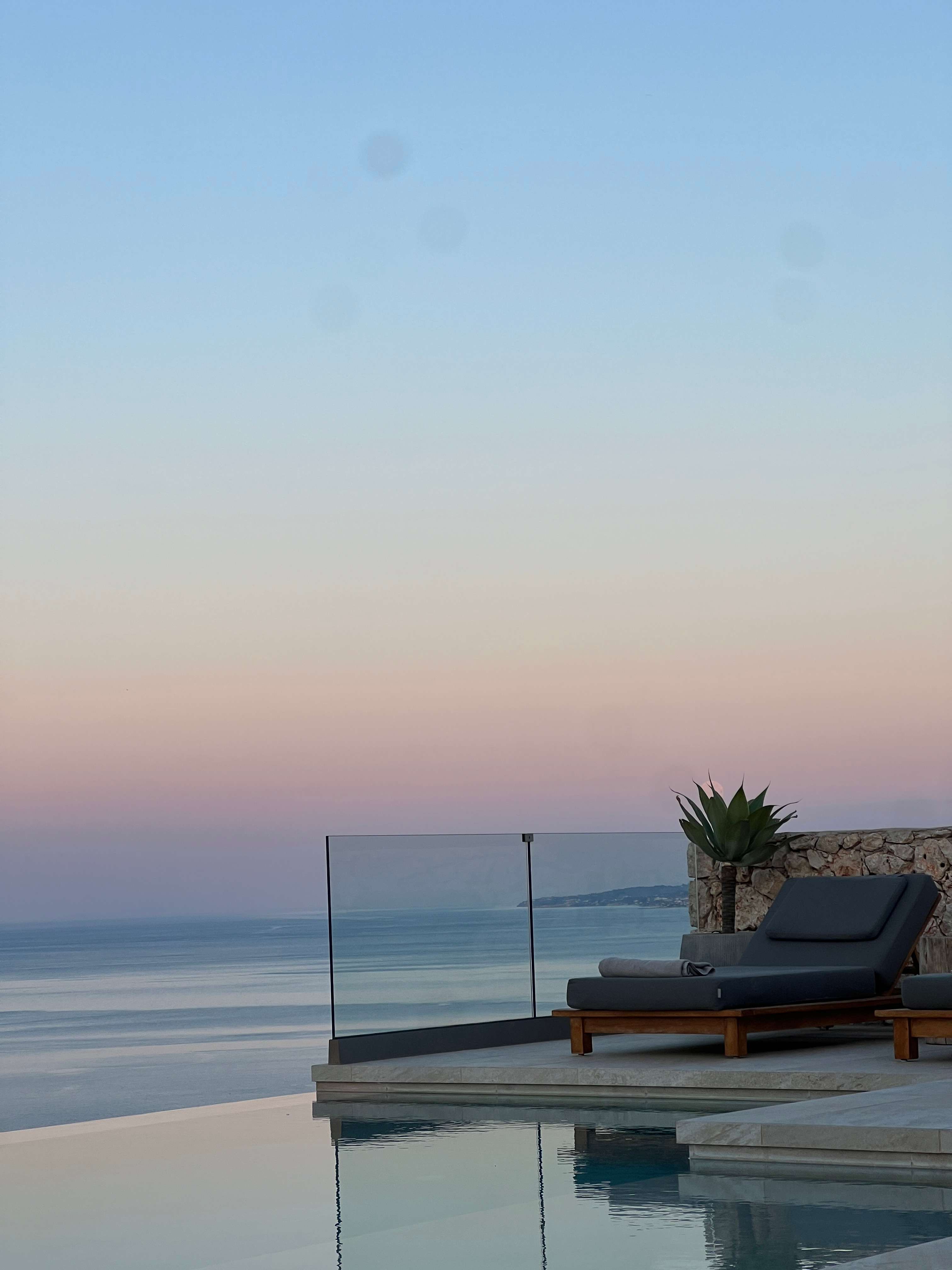 Infinity pool and loungers at dusk